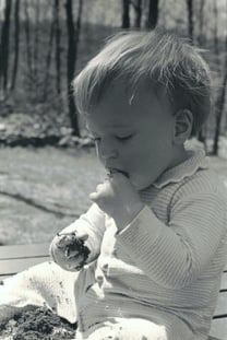 tim eating cake on his first birthday