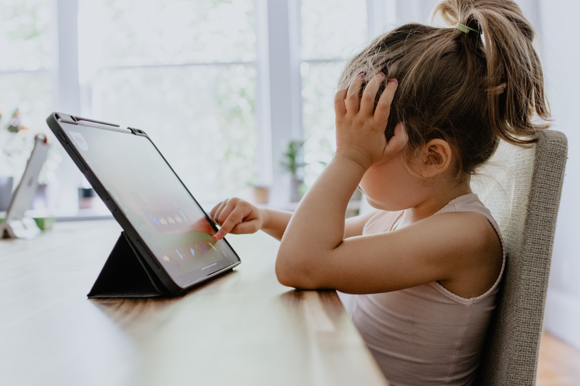 Photo of young girl on tablet by @kellysikkema from Unsplash